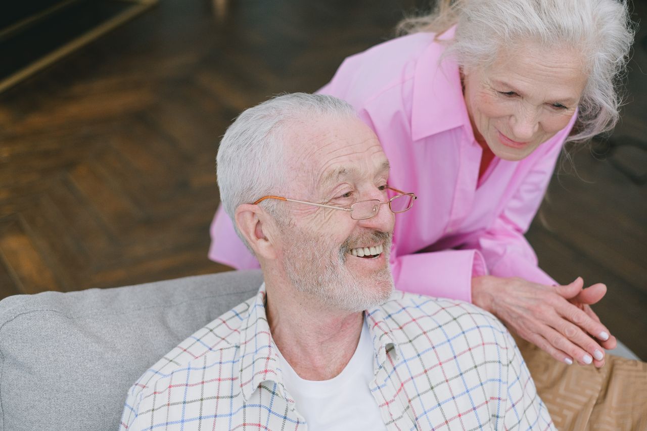 Services Elderly couple enjoying affectionate conversation at home.